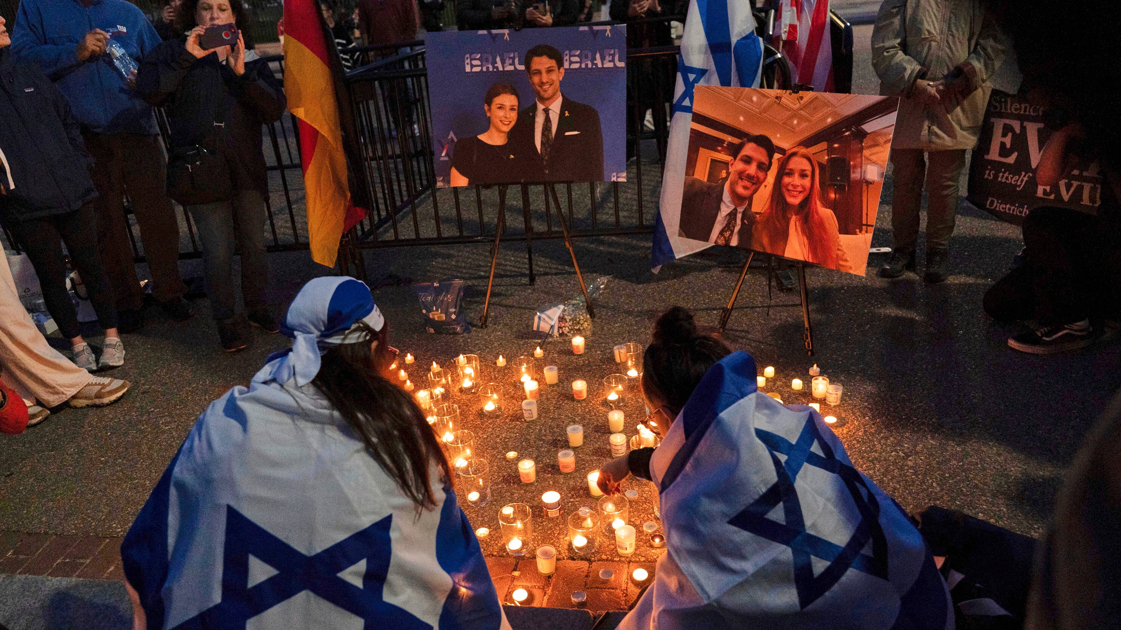 FILE - People gather to light candles in a makeshift memorial to honor Yaron Lischinsky and Sarah Milgrim who were killed as they left an event at the Capital Jewish Museum in Washington, during a candlelight vigil outside of the White House in Washington, Thursday, May 22, 2025. (AP Photo/Jose Luis Magana, File)