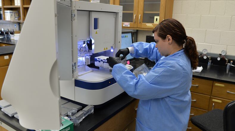 Erin Norris GBI forensic scientist is pictured using a genetic analyzer to processes a rape kit at the GBI Crime lab in Decatur in 2015. BRANT SANDERLIN/BSANDERLIN@AJC.COM
