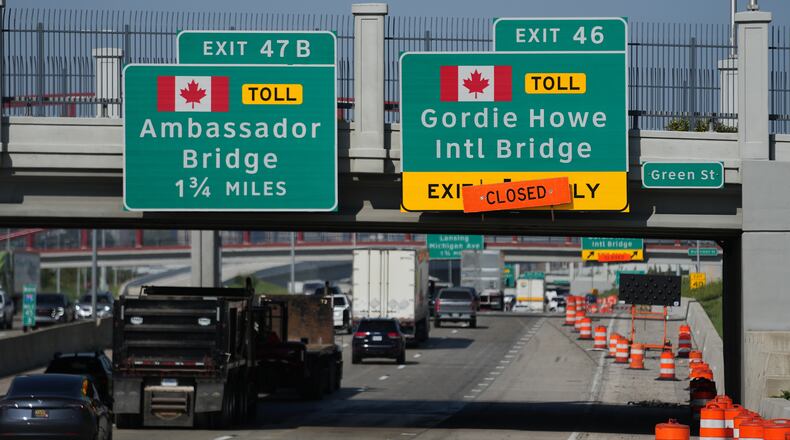 Exits from Interstate 75 are displayed for the Gordie Howe International Bridge and Ambassador Bridge connecting Windsor, Ontario, with Detroit, Tuesday, July 14, 2026, (AP Photo/Paul Sancya)