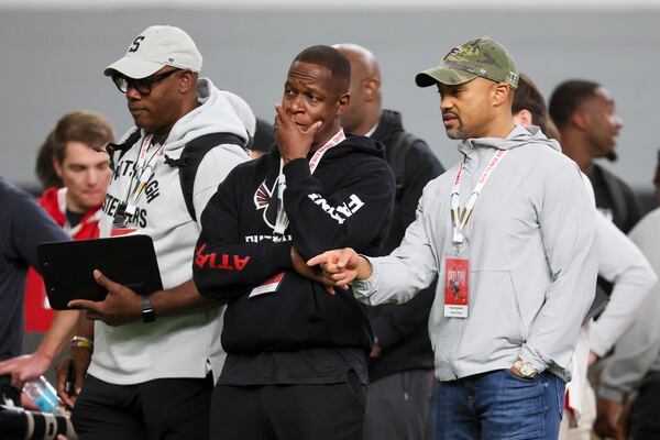 Falcons head coach Raheem Morris (center) and general manager Terry Fontenot (right) attend UGA's pro day in March.