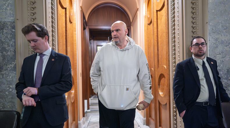 Sen. John Fetterman, D-Pa., a Democrat who has been voting to open the government, leaves the chamber as the Senate works to bring the longest government shutdown in U.S. history to an end after a bipartisan compromise, at the Capitol in Washington, Monday, Nov. 10, 2025. (AP Photo/J. Scott Applewhite)
