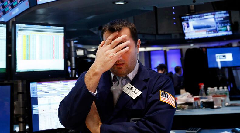 Specialist Vincent Surace works on the floor of the New York Stock Exchange Friday, Jan. 24, 2014. (AP Photo/Jason DeCrow)