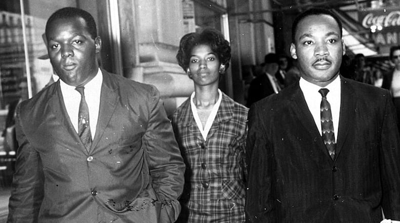 Demonstrators (l-r) Lonnie King, Marilyn Pryce (according to a source) and Martin Luther King Jr. are taken to a police car after being arrested for a sit-in protest at Rich’s. Their actions will be marked on Oct. 19, 2016 with a plaque at the location of the Rich’s Department Store protests. (Charles Jackson/AJC staff) 1960.