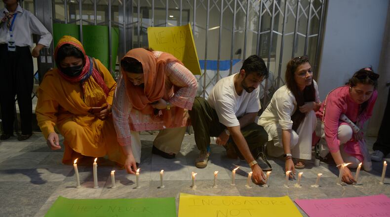 People light candles in the memory of the newborn victims outside the Mother and Child Health ward at the Pakistan Institute of Medical Sciences, in Islamabad, Pakistan, Thursday, Aug. 27, 2026. (AP Photo/M.A. Sheik)