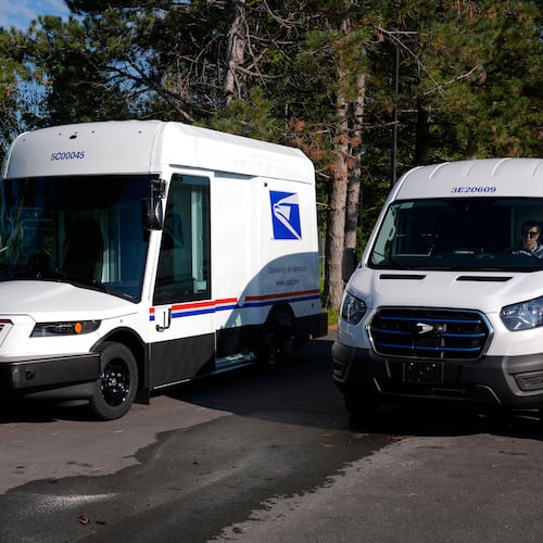 FILE - The U.S. Postal Service's next-generation delivery vehicle, left, is displayed as one new battery electric delivery trucks leaves the Kokomo Sorting and Delivery Center in Kokomo, Ind., Aug. 29, 2024. (AP Photo/Michael Conroy, File)