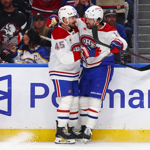 Montreal Canadiens center Alex Newhook (15) celebrates his goal with defenseman Alexandre Carrier (45) during the second period in Game 2 of a second-round NHL hockey Stanley Cup playoff series against the Buffalo Sabres Friday, May 8, 2026, in Buffalo, N.Y. (AP Photo/Jeffrey T. Barnes)
