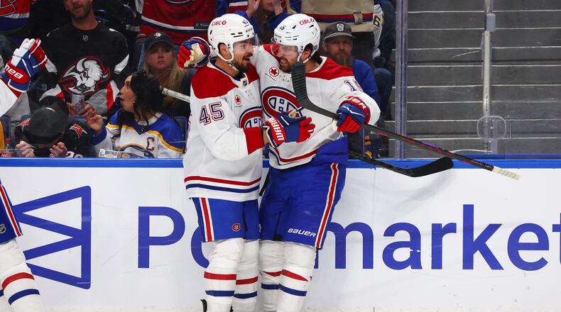 Montreal Canadiens center Alex Newhook (15) celebrates his goal with defenseman Alexandre Carrier (45) during the second period in Game 2 of a second-round NHL hockey Stanley Cup playoff series against the Buffalo Sabres Friday, May 8, 2026, in Buffalo, N.Y. (AP Photo/Jeffrey T. Barnes)