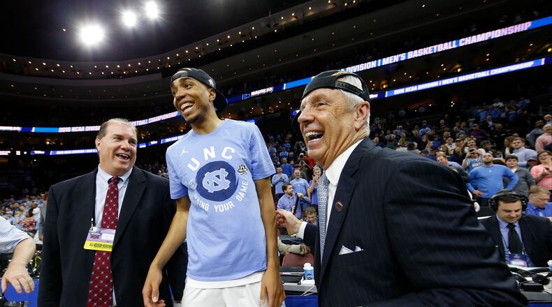 North Carolina’s Brice Johnson, center, celebrates with head coach Roy Williams, right, after winning the East Regional on Sunday, March 27, 2016, in Philadelphia. North Carolina beat Notre Dame 88-74 to advance to the Final Four. (AP Photo/Chris Szagola)