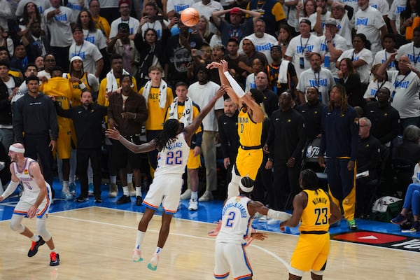 Indiana Pacers guard Tyrese Haliburton (0) shoots a 3-pointer against Oklahoma City Thunder guard Cason Wallace (22) during the second half of Game 1 of the NBA Finals basketball series Thursday, June 5, 2025, in Oklahoma City. (AP Photo/Nate Billings)