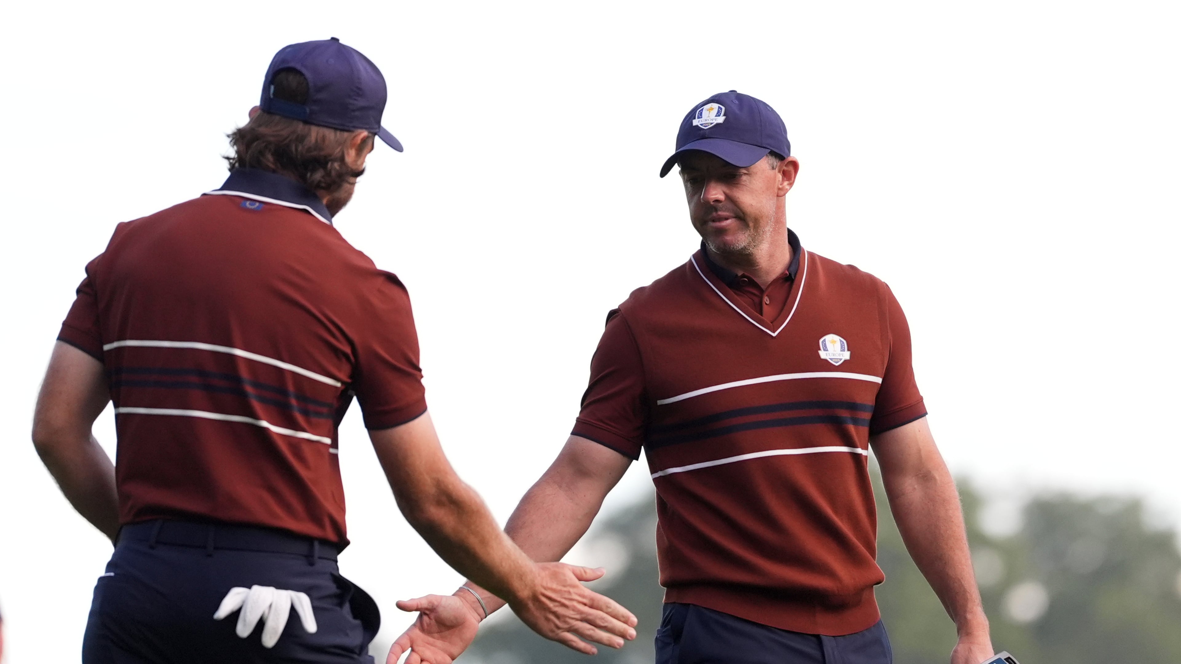 Europe's Tommy Fleetwood celebrates with Rory McIlroy on the third hole at Bethpage Black golf course during the Ryder Cup golf tournament, Saturday, Sept. 27, 2025, in Farmingdale, N.Y. (AP Photo/Lindsey Wasson)