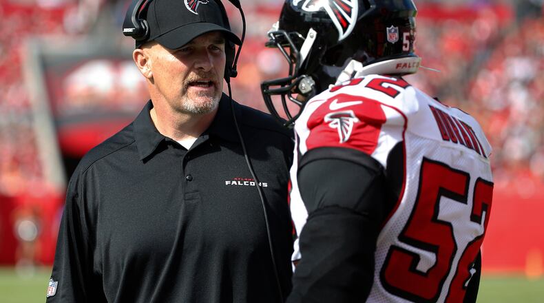 Atlanta Falcons head coach Dan Quinn talks to outside linebacker Justin Durant (52) during the first quarter of an NFL football game against the Tampa Bay Buccaneers Sunday, Dec. 6, 2015, in Tampa, Fla. (AP Photo/Brian Blanco)