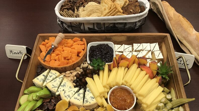 A cheeseboard is a celebration of flavors, textures, colors and aromas. Choose a variety of cheese styles — from creamy soft to hard — and different milk types. Offer them with sweet and savory accompaniments like fresh and dried fruit, nuts and spreads such as preserves, chutney, quince paste or fruit butters, along with crostini, thin baguette slices or mild crackers. LIGAYA FIGUERAS / LFIGUERAS@AJC.COM