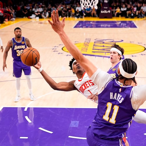 Houston Rockets guard Amen Thompson, left, shoots as Los Angeles Lakers center Jaxson Hayes defends during the first half in Game 5 of a first-round NBA playoffs basketball series Wednesday, April 29, 2026, in Los Angeles. (AP Photo/Mark J. Terrill)