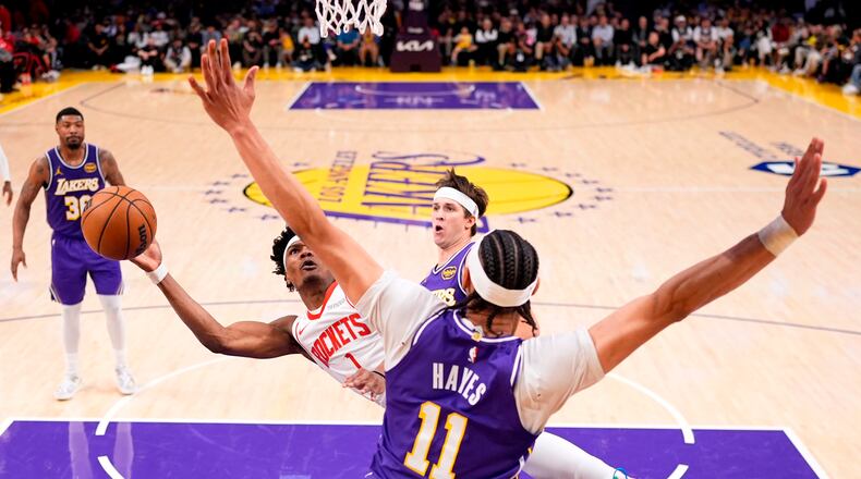 Houston Rockets guard Amen Thompson, left, shoots as Los Angeles Lakers center Jaxson Hayes defends during the first half in Game 5 of a first-round NBA playoffs basketball series Wednesday, April 29, 2026, in Los Angeles. (AP Photo/Mark J. Terrill)