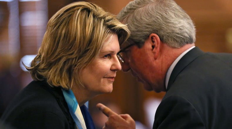 Rep. Tom Taylor, right, speaks with Speaker Pro Tem Jan Jones during last year’s legislative session. Taylor is proposing legislation to property taxes collected for DeKalb County schools. BOB ANDRES / BANDRES@AJC.COM