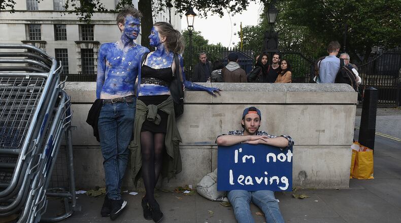 LONDON, ENGLAND- JUNE 24: A young couple painted as EU flags protest on outside Downing Street against the United Kingdom's decision to leave the EU following the referendum on June 24, 2016 in London, United Kingdom. The United Kingdom has gone to the polls to decide whether or not the country wishes to remain within the European Union. After a hard fought campaign from both REMAIN and LEAVE the vote is too close to call. A result on the referendum is expected on Friday morning. (Photo by Mary Turner/Getty Images)