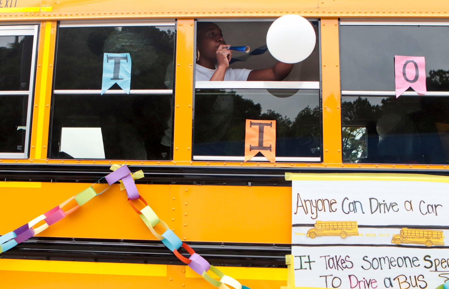 Bus drivers wave balloons during the Atlanta Public School parade on Saturday, April 22, 2023. The parade celebrated the 150th anniversary of Atlanta Public Schools and featured students, teachers and other members of the APS community. CHRISTINA MATACOTTA FOR THE ATLANTA JOURNAL-CONSTITUTION