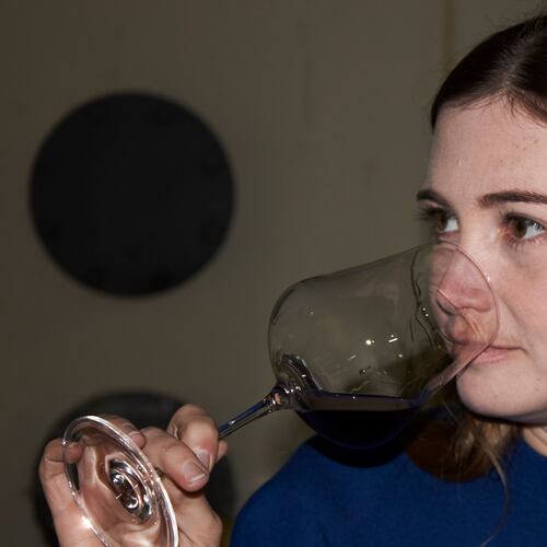 Natasha Jacka evaluates a glass of wine during the period it matures in oak in Cape Town, South Africa, Thursday, June 4, 2026. (AP Photo/Neil Shaw)