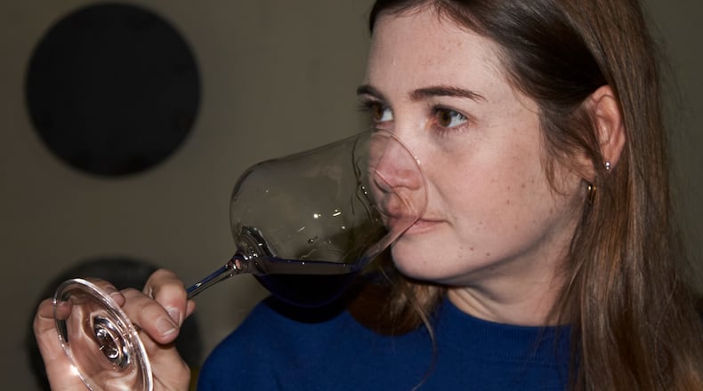 Natasha Jacka evaluates a glass of wine during the period it matures in oak in Cape Town, South Africa, Thursday, June 4, 2026. (AP Photo/Neil Shaw)
