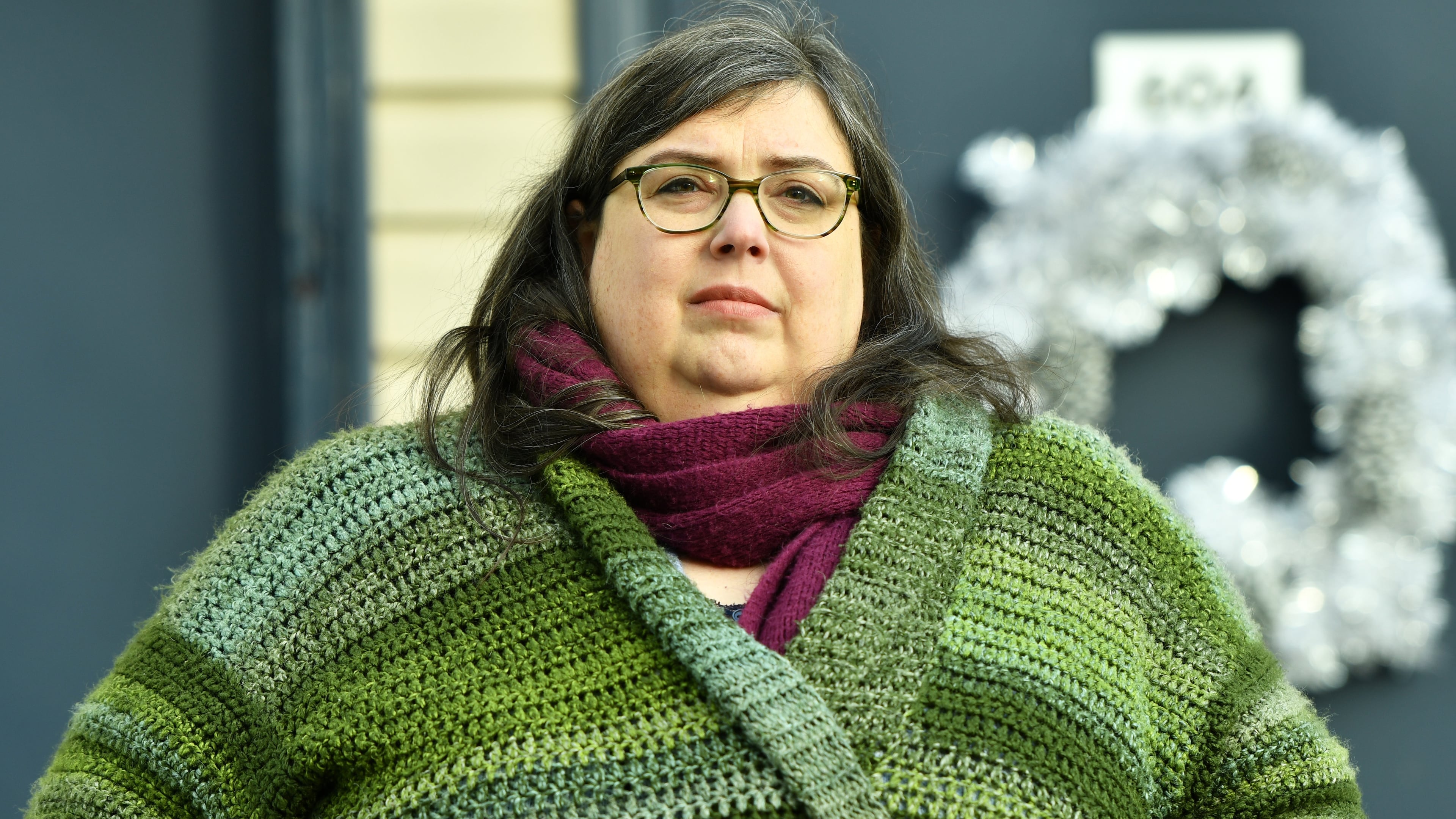 Lynn Weidner, a home care worker who worries that the cost of her health insurance plan in the Affordable Care Act marketplace will rise, poses in front of her home, Thursday, Dec. 4, 2025, in Allentown, Pa. (AP Photo/Marc Levy)