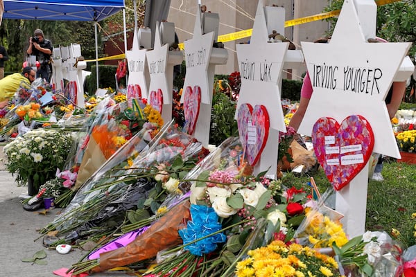 FILE - Flowers surround Stars of David, Oct. 31, 2018, part of a makeshift memorial outside the Tree of Life Synagogue to the 11 people killed during worship services Oct. 27, 2018 in Pittsburgh. (AP Photo/Gene J. Puskar, File)