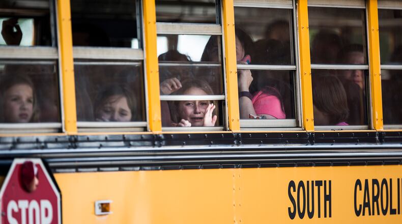 A Townville Elementary student looks out of the window of a school bus as she and her classmates are transported to Oakdale Baptist Church, following a shooting at Townville Elementary in Townville, on Sept. 28, 2016. A teenager killed his father at his home Wednesday before going to the nearby elementary school and opening fire with a handgun, wounding two students and a teacher, authorities said.