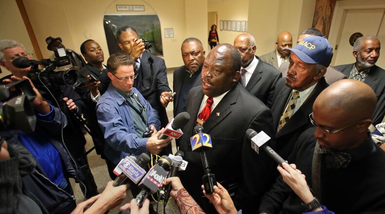 Edward DuBose, President of the Georgia State Conference NAACP, center, talks with members of the media following a meeting with Gov. Nathan Deal at the Capitol Monday afternoon in Atlanta, Ga., March 11, 2013. The meeting, which was closed to the public, was about the removal of six DeKalb school board members earlier this month. JASON GETZ / JGETZ@AJC.COM