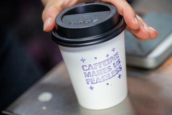 A carryout cup of coffee served at Finca to Filter. (Jenni Girtman for the AJC)