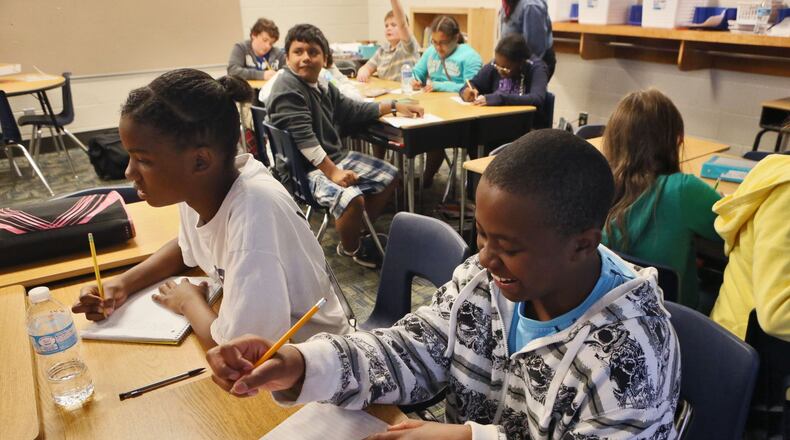 Chloe Pollock (left) and Jeromiah Walker work on a math problem in Holly Bradley’s 5th grade math class. The class was playing a game, and the students were having fun while trying to be first with the answer. Dorsett Shoals Elementary made a huge leap on the College and Career-Ready Performance Index, lifting its grade from a 60.2 to an 88.1. BOB ANDRES / BANDRES@AJC.COM