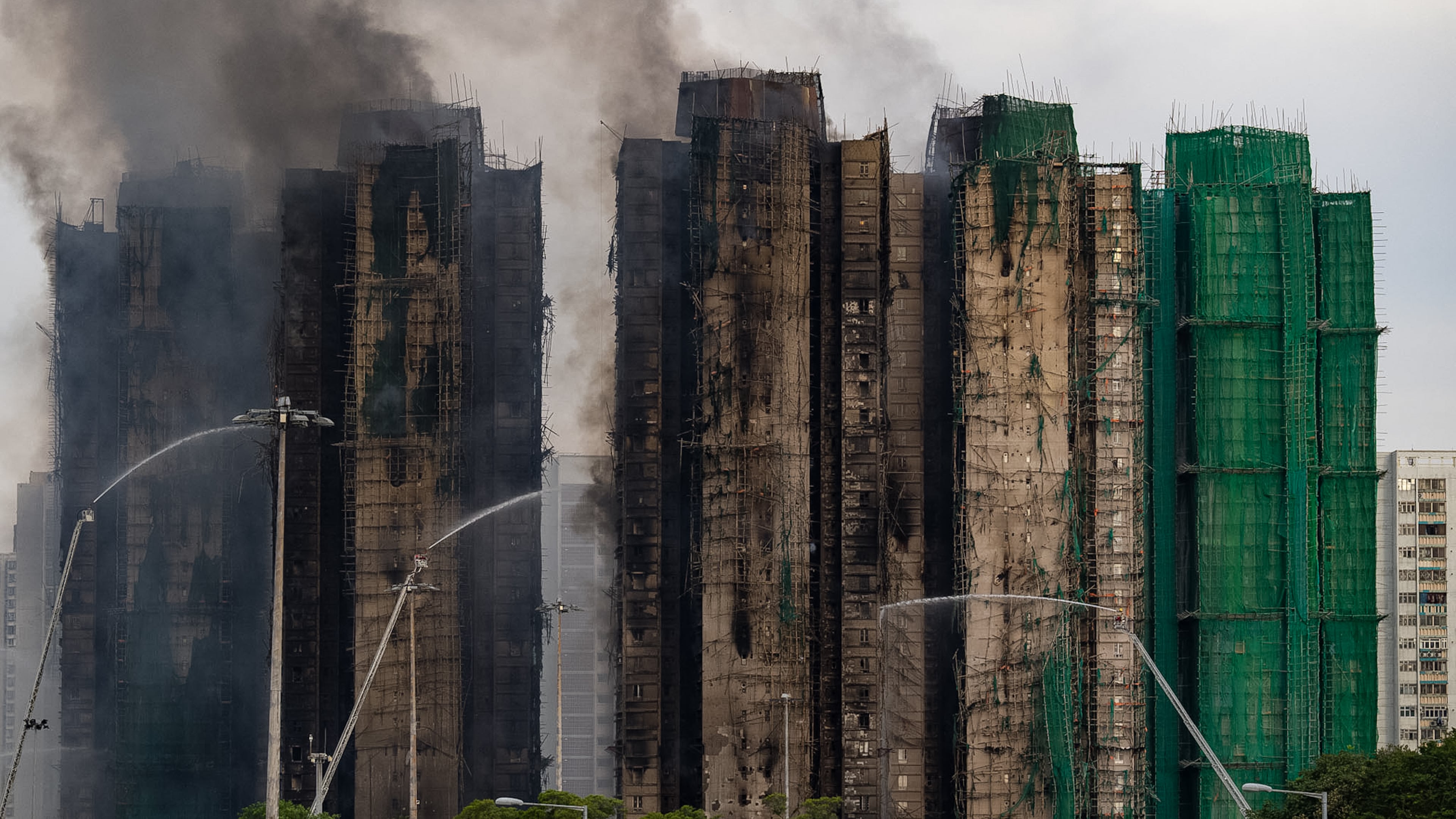 Firefighters work to extinguish a fire which broke out Wednesday at Wang Fuk Court, a residential estate in the Tai Po district of Hong Kong's New Territories, Thursday, Nov. 27, 2025. (AP Photo/Chan Long Hei)