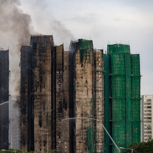 Firefighters work to extinguish a fire which broke out Wednesday at Wang Fuk Court, a residential estate in the Tai Po district of Hong Kong's New Territories, Thursday, Nov. 27, 2025. (AP Photo/Chan Long Hei)