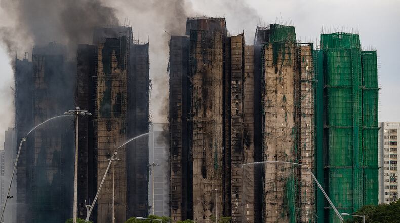 Firefighters work to extinguish a fire which broke out Wednesday at Wang Fuk Court, a residential estate in the Tai Po district of Hong Kong's New Territories, Thursday, Nov. 27, 2025. (AP Photo/Chan Long Hei)