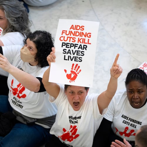 FILE - Demonstrators protest against cuts to American foreign aid spending, including USAID and the PEPFAR program to combat HIV/AIDS, at the Cannon House Office Building on Capitol Hill, Wednesday, Feb. 26, 2025, in Washington. (AP Photo/Mark Schiefelbein, File)