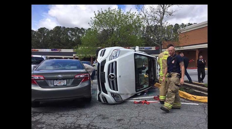 A woman flipped her car after leaving Kroger on Roswell Road on Thursday, April 6, 2017. // Sandy Springs Police