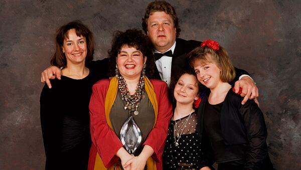 BEVERLY HILLS, CA - 1989: The cast of Roseanne, (l-r) Laurie Metcalf, Roseanne Barr, John Goodman, Sara Gilbert and Lecy Goranson, pose backstage after winning the 1989 People's Choice Award for best TV Comedy in Beverly Hills, California. (Photo by George Rose/Getty Images)