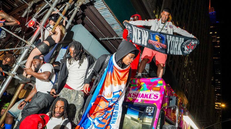 New York Knicks fans celebrate on the street outside of a watch party in Bryant Park for Game 3 of the NBA Finals basketball series between the Knicks and the San Antonio Spurs, Monday, June 8, 2026, in New York. (AP Photo/Ryan Murphy)