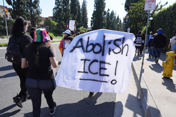 People march along a street during a protest on Wednesday, June 11, 2025, in Paramount, Calif. (AP Photo/Jae C. Hong, File)