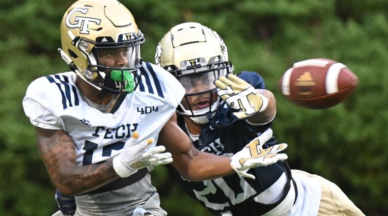 Georgia Tech wide receiver Malik Rutherford (12) makes a catch under pressure from Tech defensive back LaMiles Brooks (20) during the first football practice of the season at Rose Bowl Field in Atlanta on Friday, August 5, 2022. (Hyosub Shin / Hyosub.Shin@ajc.com)