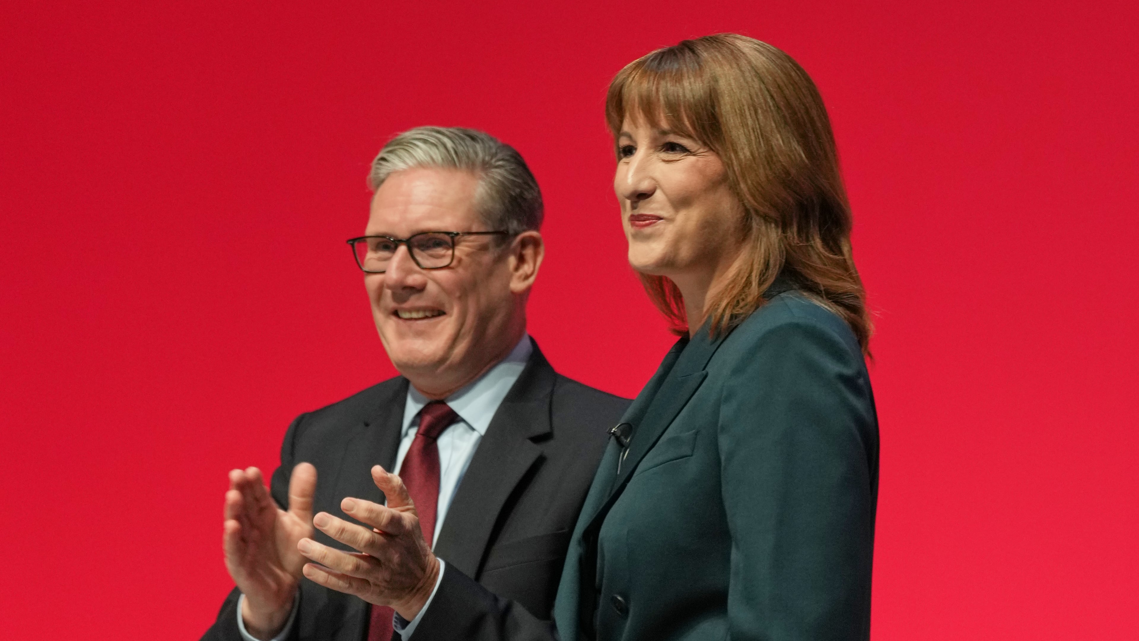 Britain's Chancellor of the Exchequer Rachel Reeves, left, stands next to the Prime Minister Keir Starmer, who applauds after she gave her keynote speech during the annual Labour Party conference in Liverpool, England, Monday, Sept. 29, 2025. (AP Photo/Jon Super)
