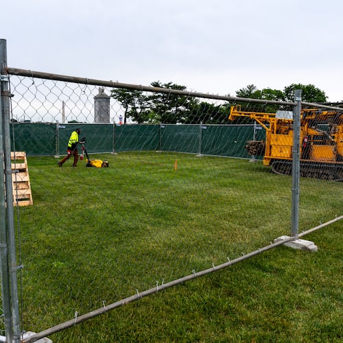 Workers survey the Memorial Circle, where President Donald Trump has proposed building an arch to commemorate the United States' 250th anniversary, Monday, May 11, 2026, in Washington. (AP Photo/Alex Brandon)