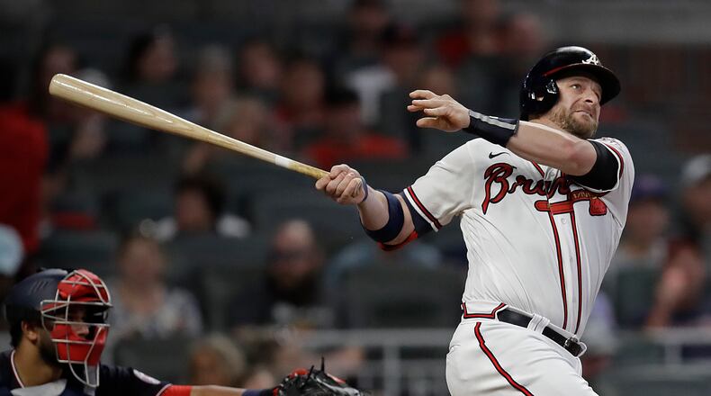 Atlanta Braves' Stephen Vogt watches his home run off Washington Nationals pitcher Erick Fedde during the third inning of a baseball game Thursday, Sept. 9, 2021, in Atlanta. (AP Photo/Ben Margot)