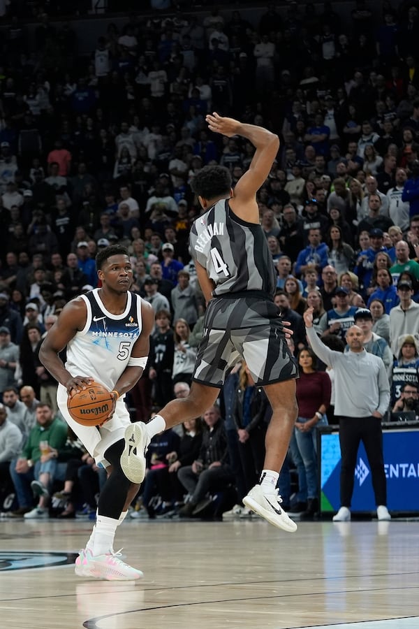 Minnesota Timberwolves guard Anthony Edwards (5) looks to shoot as Brooklyn Nets guard Reece Beekman (4) defends during the first half of an NBA basketball game, Friday, April 11, 2025, in Minneapolis. (AP Photo/Abbie Parr)