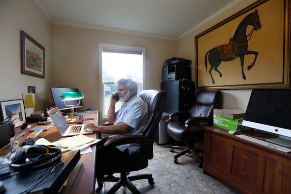 FILE - Dr. Robert Malone works in his office on his horse farm in Madison, Va., July 22, 2020. (AP Photo/Steve Helber, File)