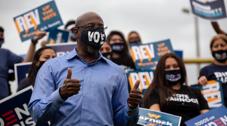 US senate candidate Rev. Raphael Warnock meets campaign volunteers at the Get Out The Early Vote with Jon Ossoff, Rev. Raphael Warnock, Carolyn Bourdeaux, and the Biden Campaign at Shorty Howell Park in Duluth, Georgia, on Saturday, October 24, 2020. (Rebecca Wright for the Atlanta Journal-Constitution)