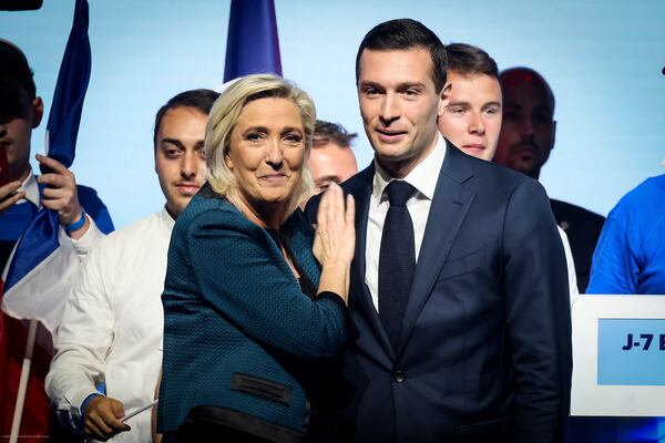FILE - Leader of the French far-right National Rally Marine Le Pen, left, and Jordan Bardella, lead candidate of the party for the upcoming European election, right, are seen during a political meeting on June 2, 2024, in Paris. (AP Photo/Thomas Padilla, File)