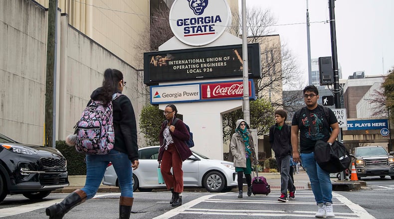 03/10/2020 -- Atlanta, Georgia -- Students navigate Georgia State University's main campus in Atlanta, Tuesday, March 10, 2020. Georgia State University students are urging the campus to follow the example of dozens of colleges around the country and move to online classes in the face of the mounting coronavirus threat. A petition for online classes collected more than 11,000 signatures overnight, helped along by a news story about the effort in the Signal, the GSU student newspaper. (ALYSSA POINTER/ALYSSA.POINTER@AJC.COM)