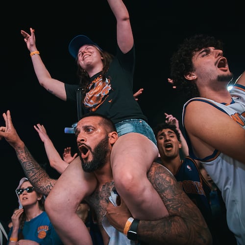 New York Knicks fans celebrate as they watch Game 5 of the NBA Finals basketball series against the San Antonio Spurs, Saturday, June 13, 2026, in New York. (AP Photo/Andres Kudacki)