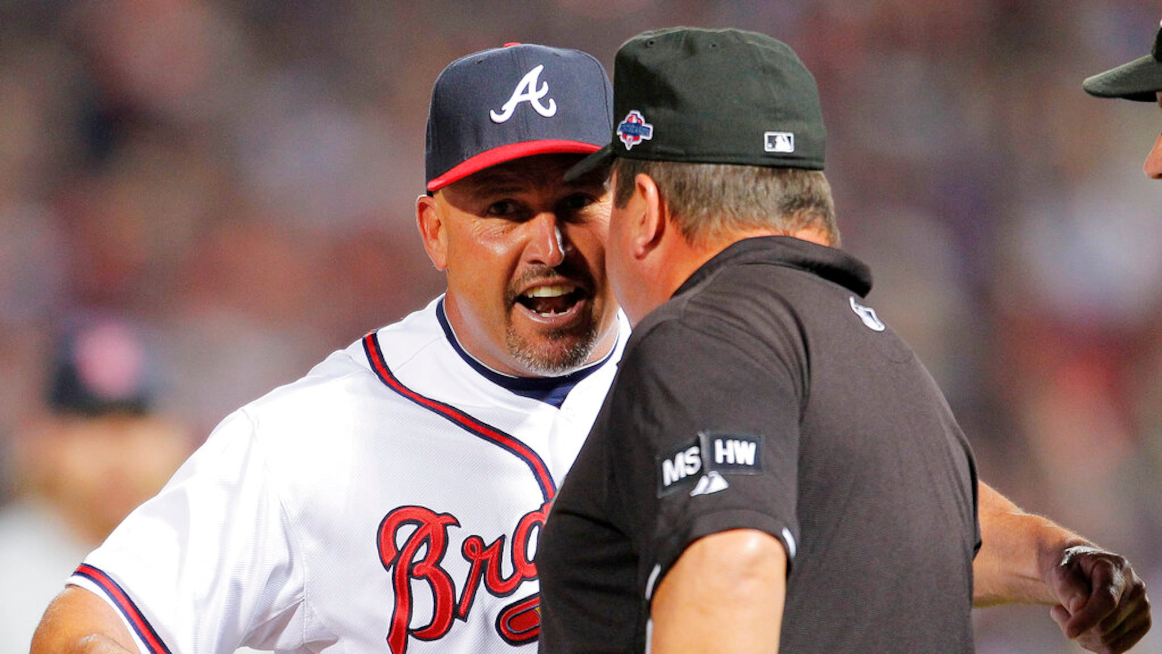 Umpire Sam Holbrook, right, listens to then-Atlanta Braves manager Fredi Gonzalez, left, after a call during the eighth inning of the National League wild card playoff baseball game against the St. Louis Cardinals, Friday, Oct. 5, 2012, in Atlanta. The game was stopped after officials decided Braves' Andrelton Simmons was out on the infield fly rule. (AP Photo/Todd Kirkland)