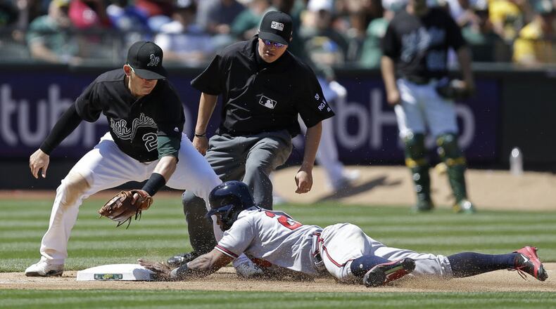 Braves utility man Danny Santana slides into third base with one of three steals he had in a July 1 game at Oakland. (AP Photo/Ben Margot)