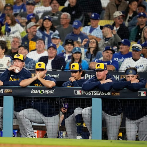 Members of the Milwaukee Brewers watch during the eighth inning in Game 4 of baseball's National League Championship Series against the Los Angeles Dodgers, Friday, Oct. 17, 2025, in Los Angeles. (AP Photo/Ashley Landis)